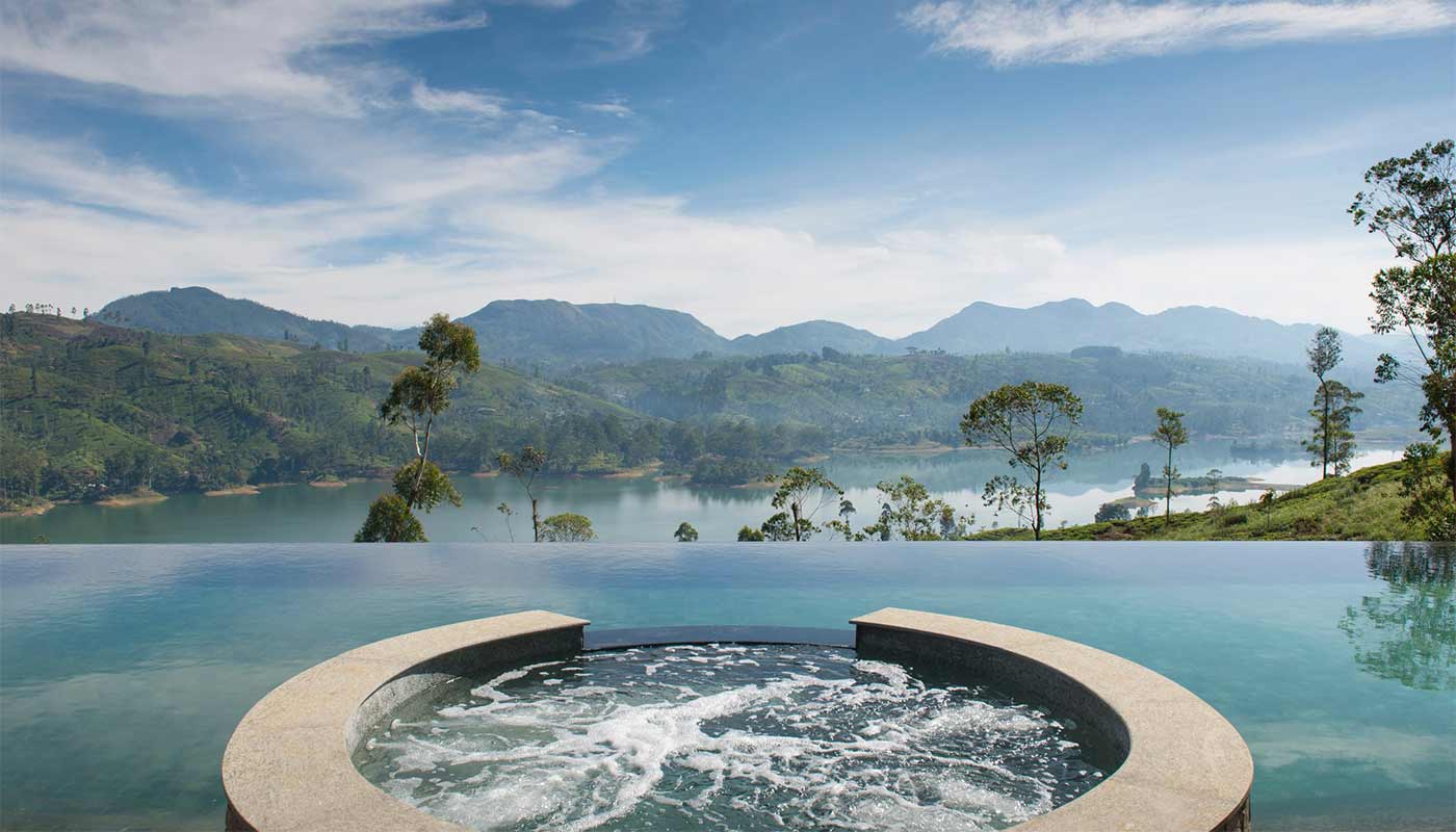 A breathtaking view from a luxury resort pool overlooking the sea and mountains.