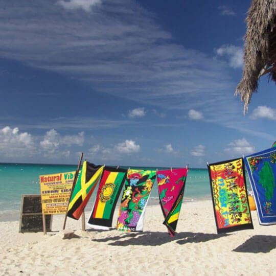 Colourful beach towels on the white sands in Jamaica.