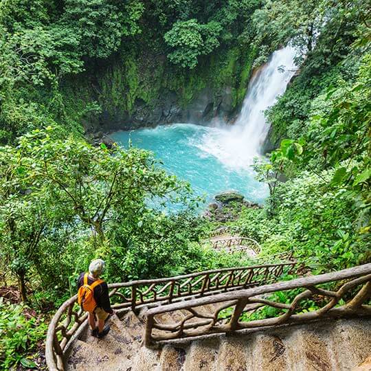 Walking down ancient steps to a beautiful waterfall in costa rica.