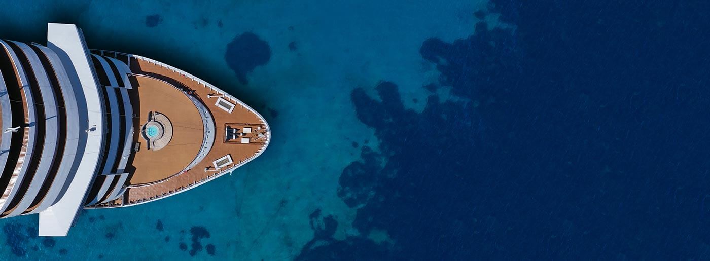 An aerial shot of a superyacht on luxury cruise holidays on the mediterranean sea.