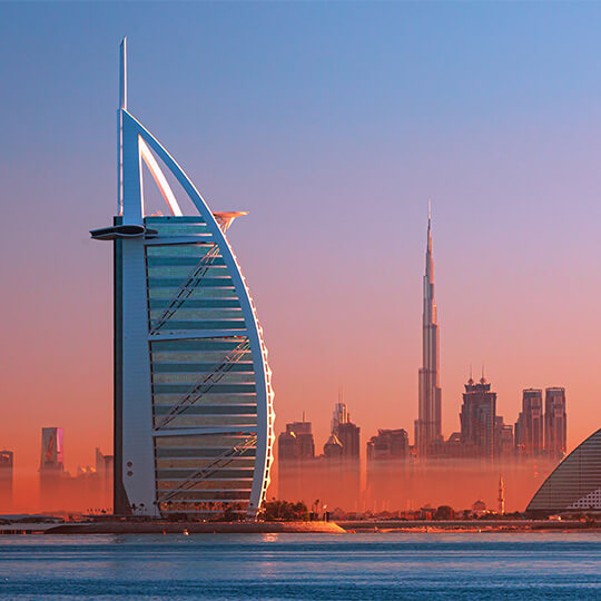 Gorgeous pink sunset over the Dubai city skyline and famous Jumeirah beach.
