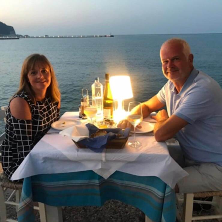 On holiday in the Greek Islands enjoying a beachfront dinner.