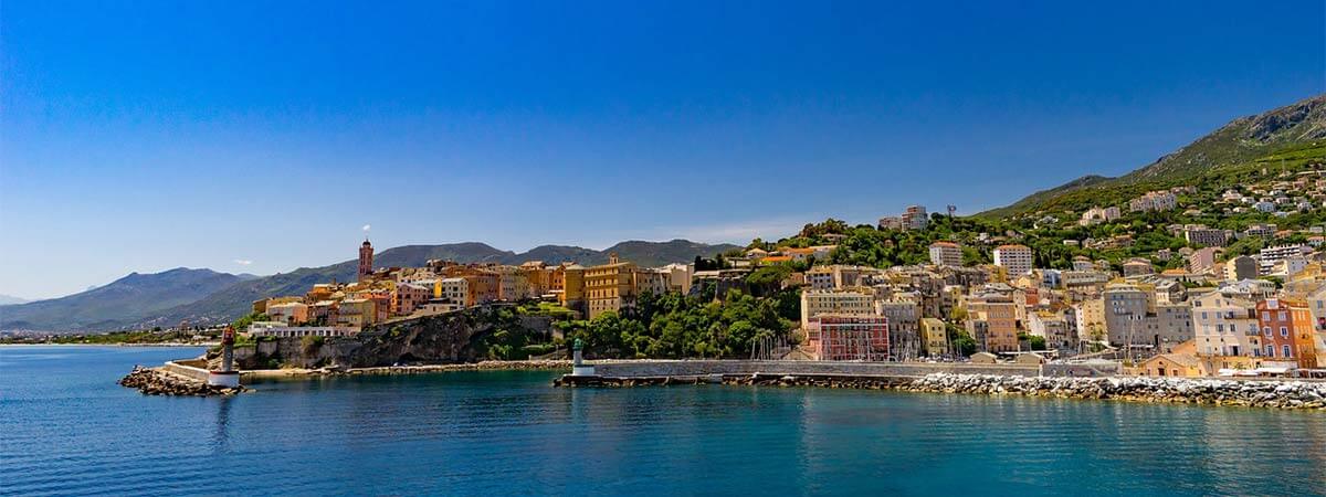 Holiday villas set in the lush green hills of a peninsula on holiday in corsica.