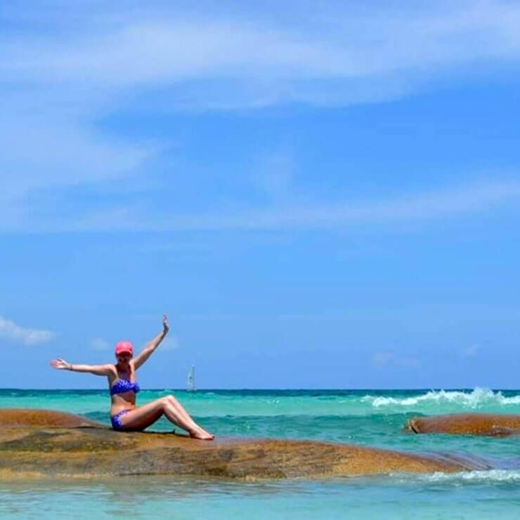 Sitting in the clear blue ocean of Mexico on a holiday trip.