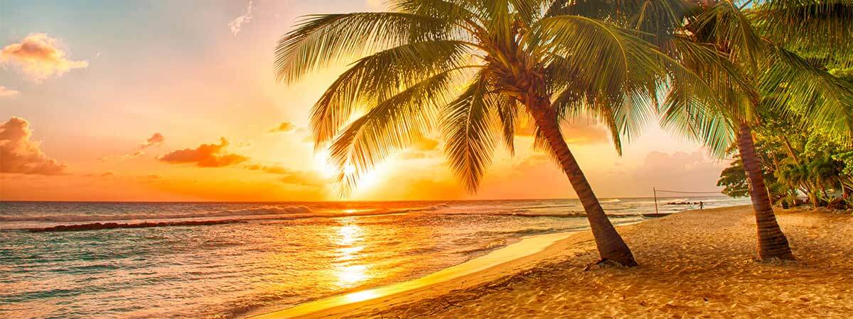 Stunning sunset in yellows and oranges over the ocean in Jamaica.