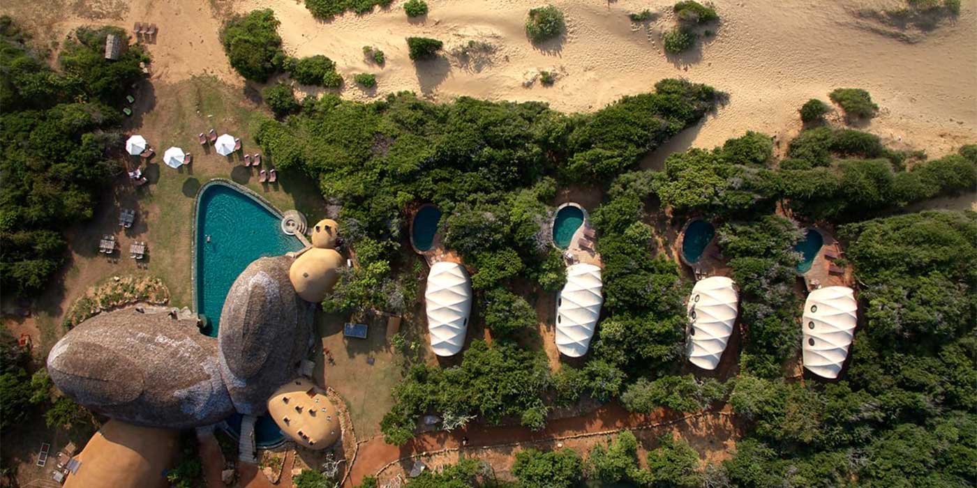 A holiday with a difference, with secluded sleeping pods in the midst of a large luxury resort in the forest.