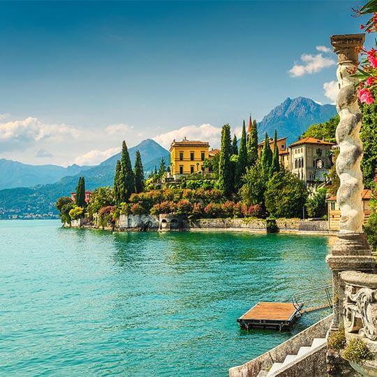 Seafront italian village, a favourite for honeymoon holidays, against a mountain view.