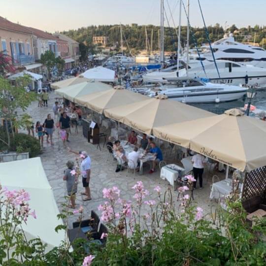 Stalls lining the port in front of luxury holiday yachts in kefalonia.