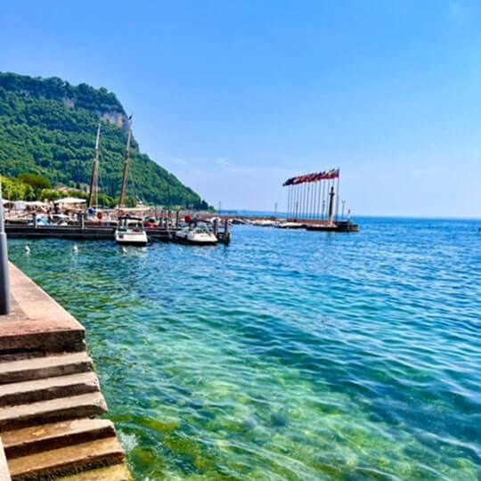 View of the bay at Lake Garda, with bright blue mediterranean water.