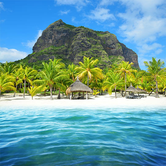 A luxury beachfront villa on the island of Mauritius, with white sands and blue sea.