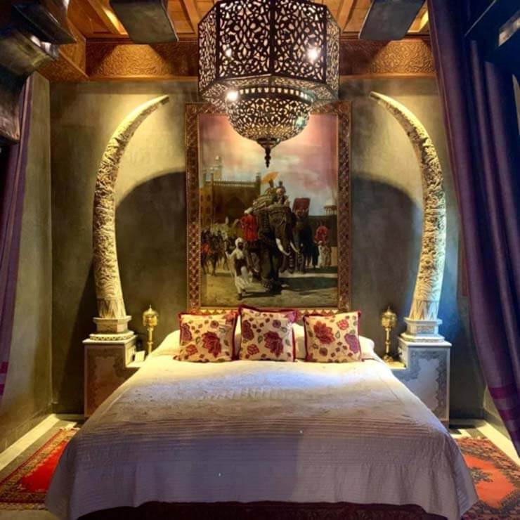 An opulent bedroom in a luxury resort in Morocco, with beautiful decor.