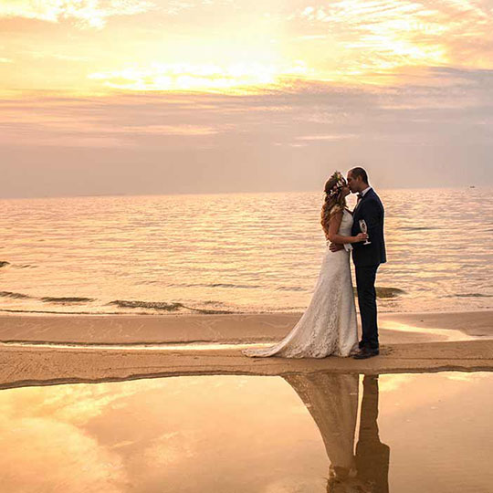 Couple getting married on the beach overseas.