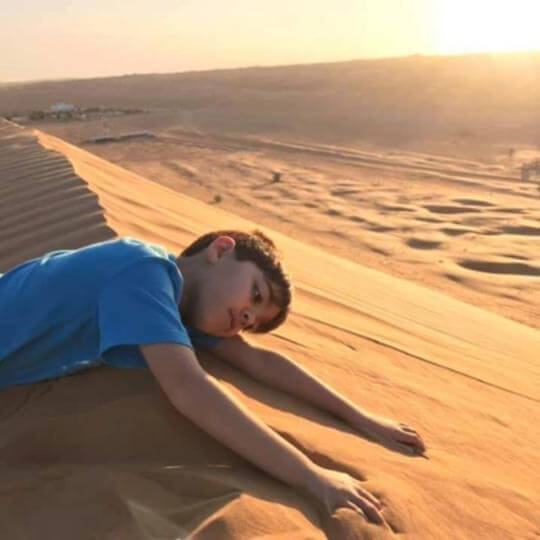 Lying on the sands dunes on holiday in Oman.