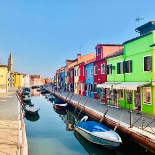 Colourful buildings and boats in venice.