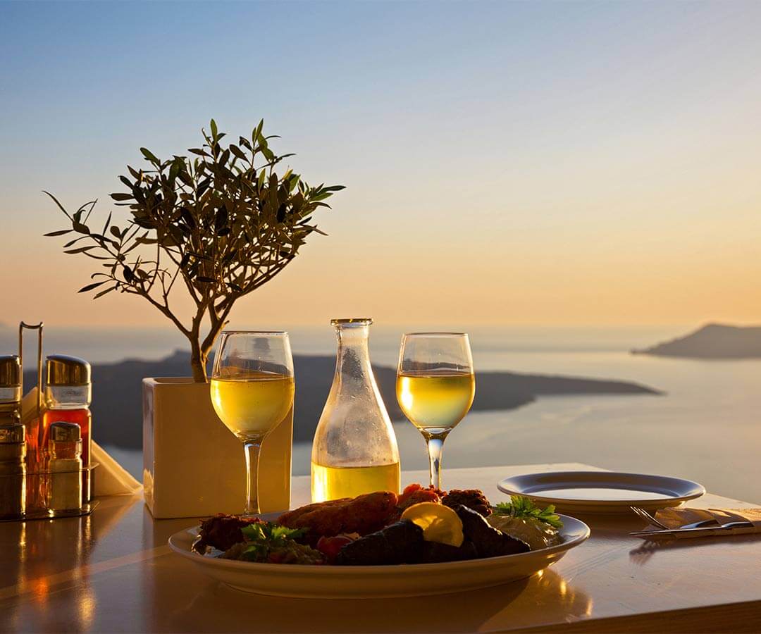 A bottle of wine and two glasses at a holiday villa, one of the things travel agents do for their clients.