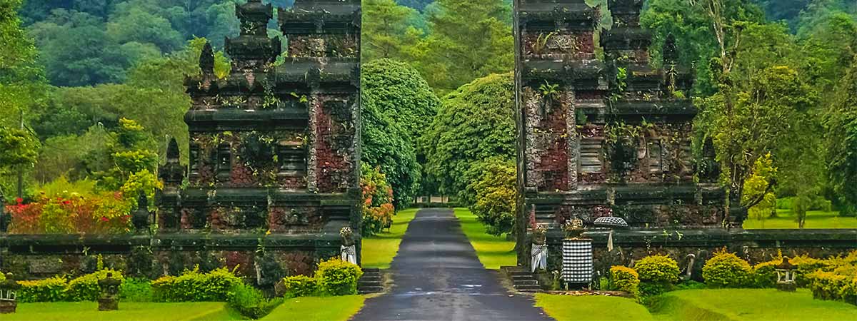 A famous temple in bali, surrounded by lush green indonesian rainforests.