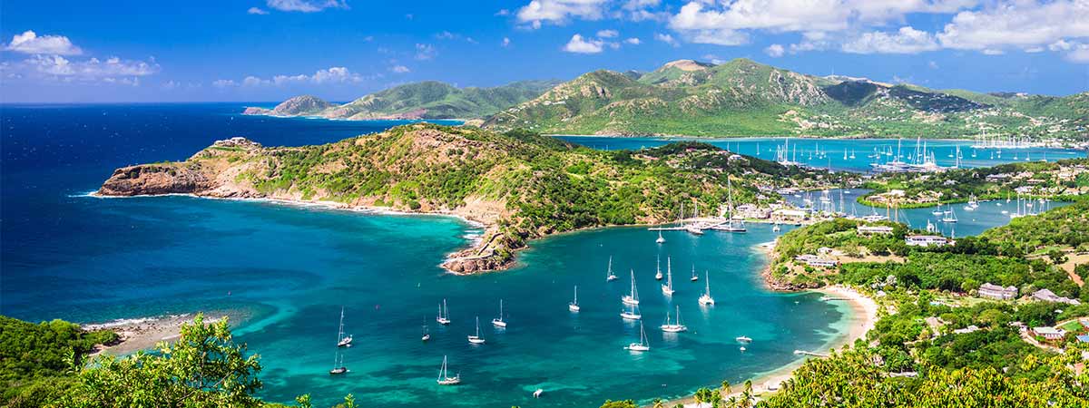 Drone view of the exotic bay in Antigua, with luxury yachts moored to the jetties.