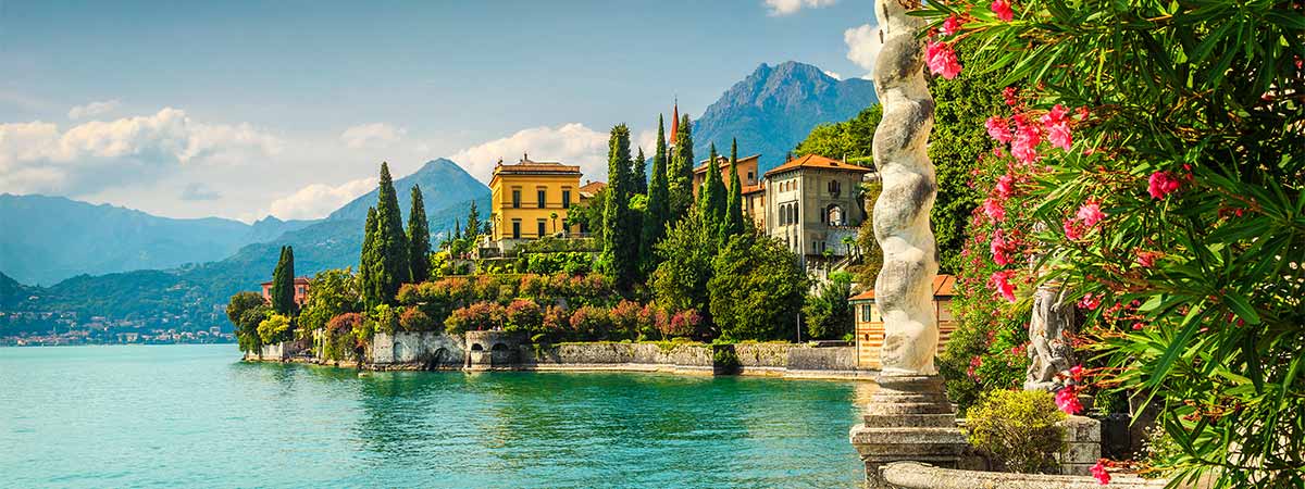 A seafront village in Italy, framed by ancient buildings and glistening waters.