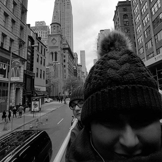 Riding the open top sightseeing bus on holiday in new york.