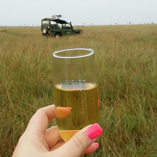 Enjoying a glass of wine on the plains on safari in kenya.
