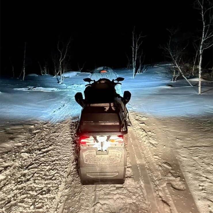 Taking a ride in a snow mobile whilst visiting Finland to hunt for the northern lights.