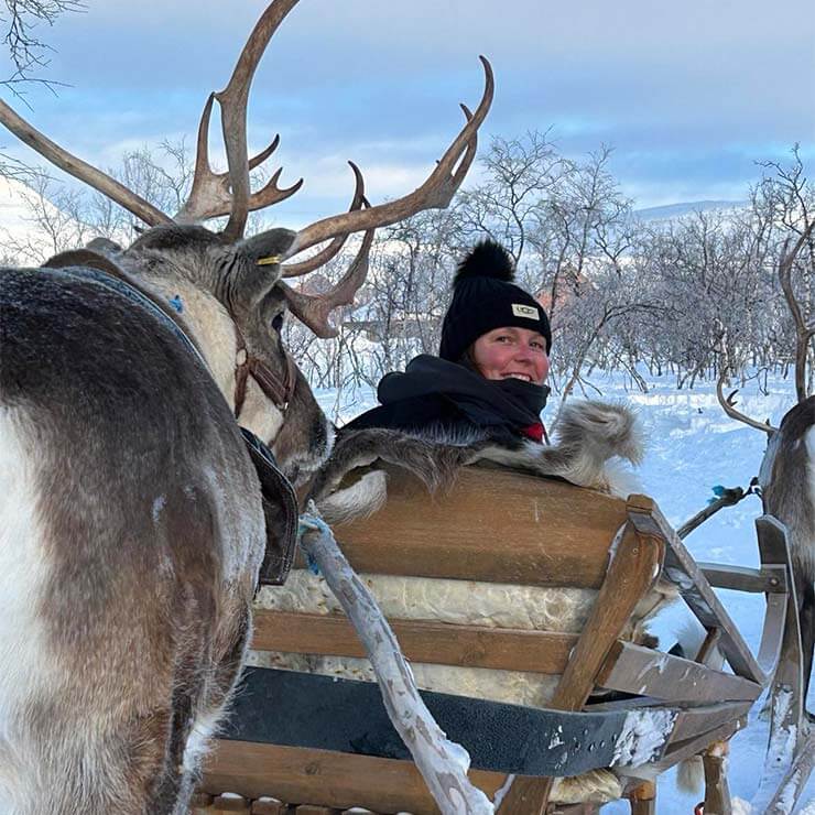 Off on a sleigh ride in Lapland, at the northern tip of Finland, pulled by reindeer in the snow.