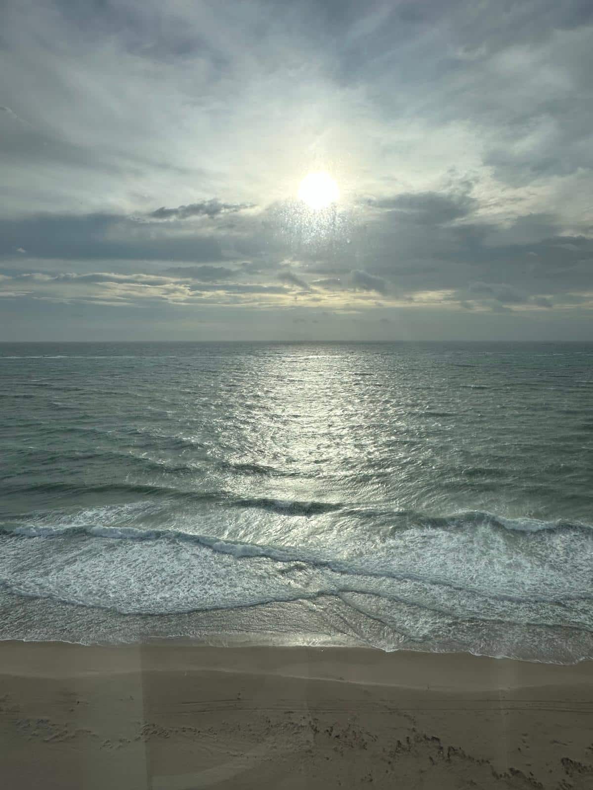 Dramatic sunset over Fort Lauderdale beach with sunlight reflecting on ocean waves