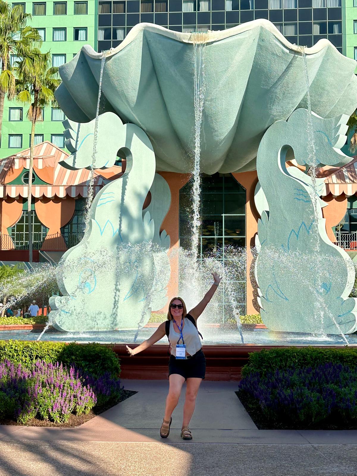 Giant seashell fountain at Disney's Swan and Dolphin Resort with visitor posing in front