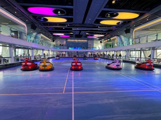 Colorful indoor SeaPlex venue with bumper cars and modern lighting aboard Royal Caribbean's Anthem of the Seas