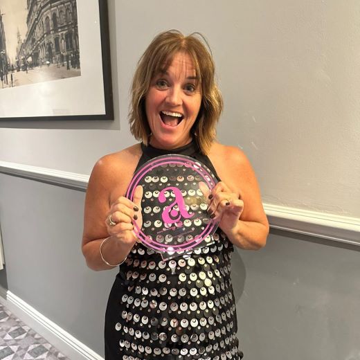 Once in a Lifetime Holidays' Joan Jones celebrating receiving the UK's Best Small Luxury Business 2024 award