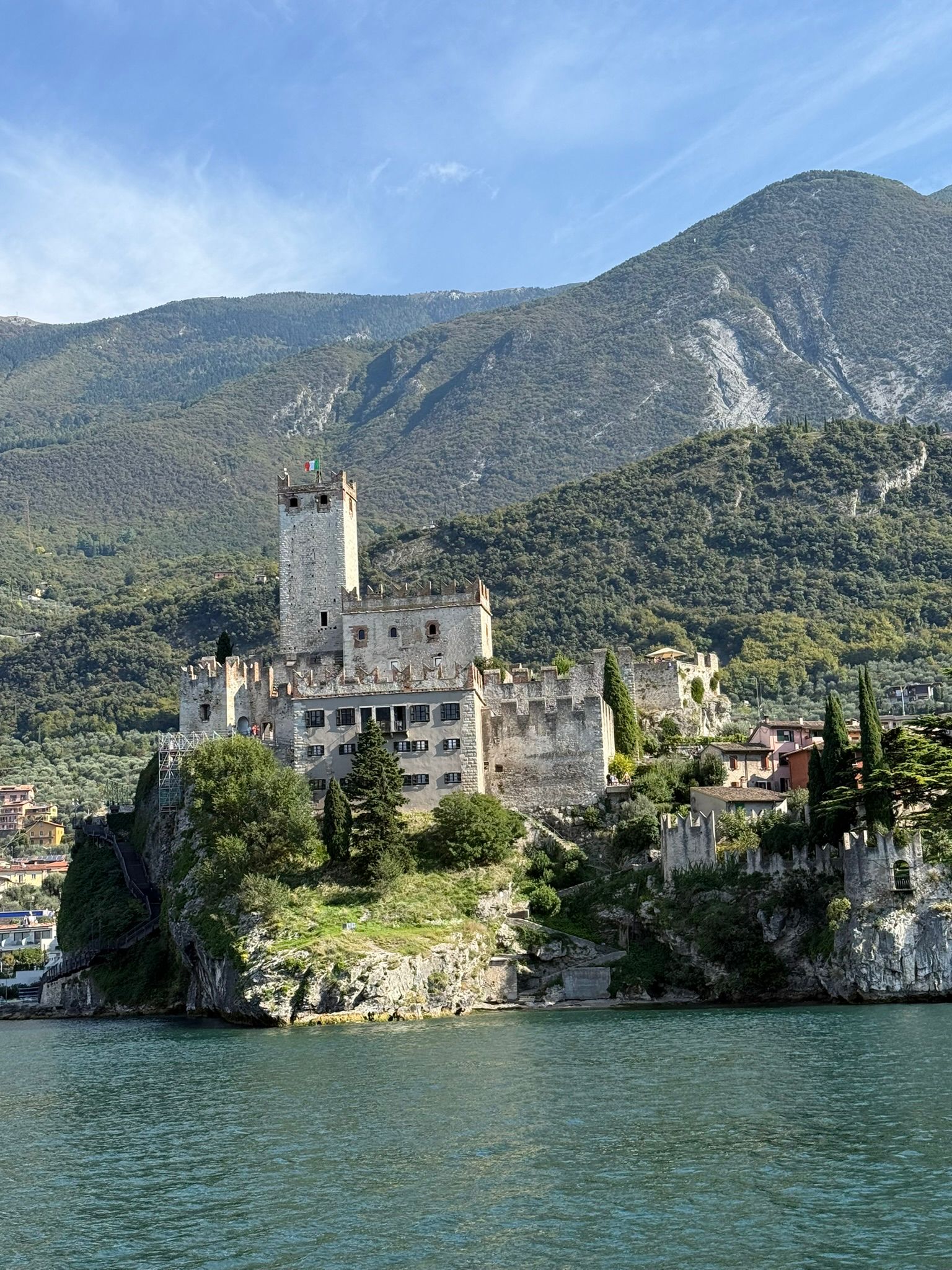 Scaligero Castle perched on a rocky promontory above the turquoise waters of Lake Garda, Italy