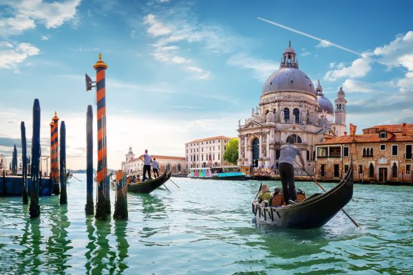 Gondolas on the Grand Canal in Venice with the Santa Maria della Salute basilica in the background